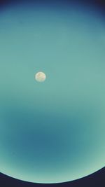 Low angle view of moon against blue sky