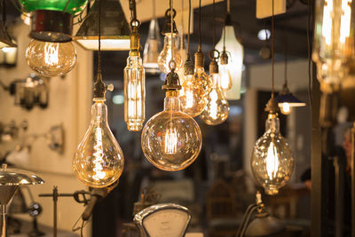 Close-up of illuminated chandelier hanging from ceiling