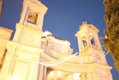 Low angle view of illuminated building against sky