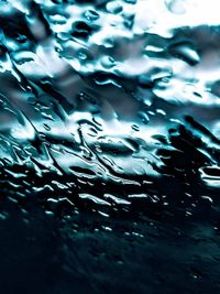 Full frame shot of raindrops on water