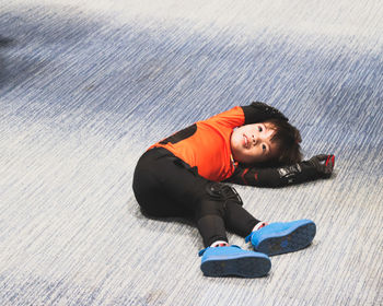 High angle portrait of woman lying on floor