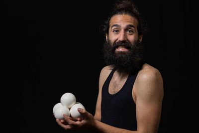 Portrait of man against black background