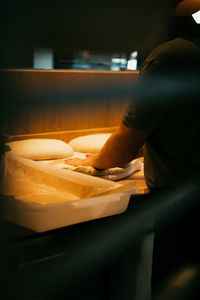 Rear view of woman sitting on sofa at home