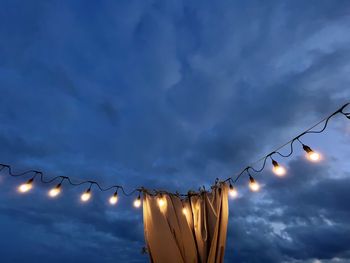 Low angle view of illuminated street light against sky