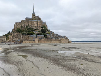 Island of mont saint-michel on a grey day at low tide