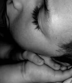 Close-up of boy sleeping at home