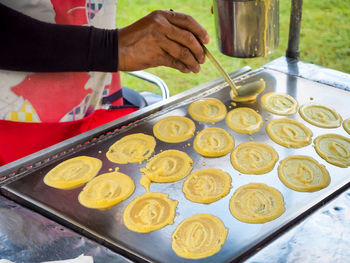 Midsection of man preparing food in kitchen