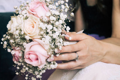 Midsection of woman holding flower bouquet