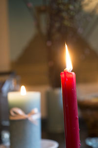 Close-up of lit candles on table