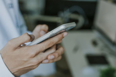 Midsection of woman using mobile phone