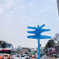 Traffic on road in city against sky