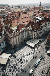 High angle view of people walking on street amidst buildings in city