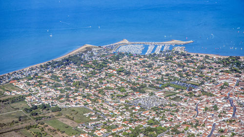 High angle view of buildings by sea