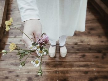 Close-up of woman holding flowers