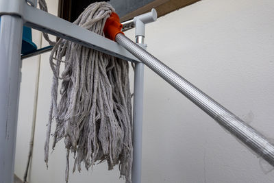 Low angle view of rope hanging on metal wall