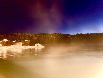 Scenic view of lake against sky during winter