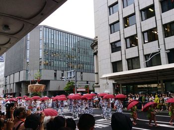 Group of people in front of buildings