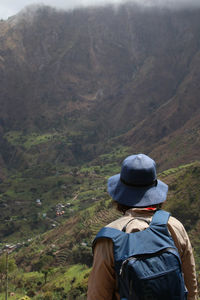 Rear view of man looking at mountains