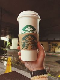 Midsection of woman holding coffee cup