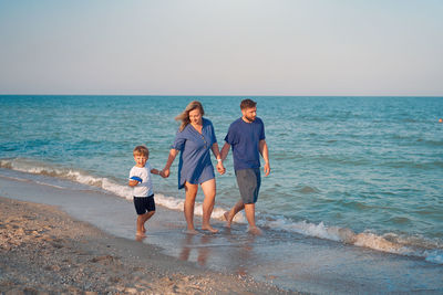 People on beach against sky