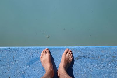 Low section of man standing on retaining wall