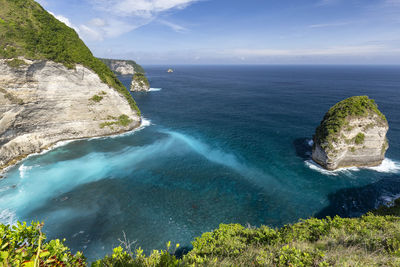 High angle view of rocks in sea against sky