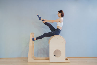 Low angle view of woman exercising on table