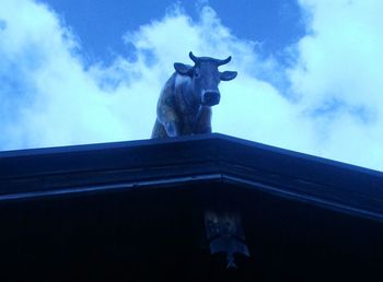 Low angle view of statue against cloudy sky