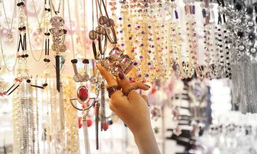 Close-up of woman buying necklace in market