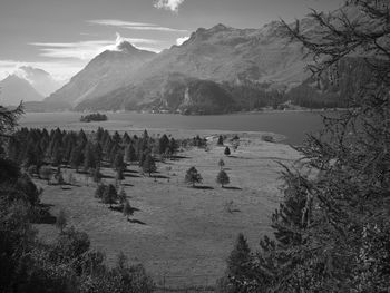 Scenic view of lake and mountains against sky