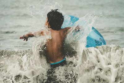 Man splashing water in sea