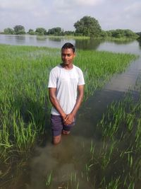 Portrait of young man standing on field