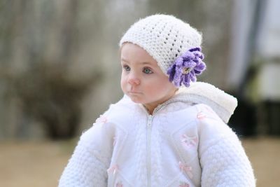 Cute baby girl looking away