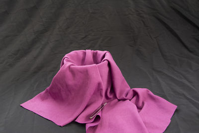 High angle view of pink fabric on bed