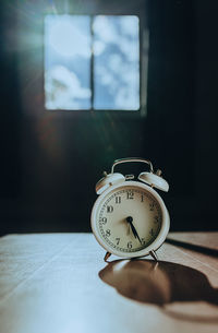 Close-up of clock on table