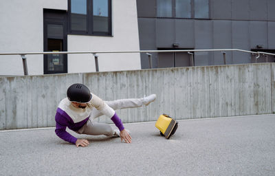 Man falling from one wheel on street