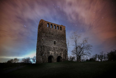 Low angle view of castle against sky at night