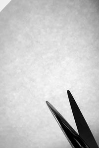 Close-up of airplane wing against sky