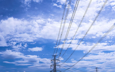 Low angle view of electricity pylon against sky