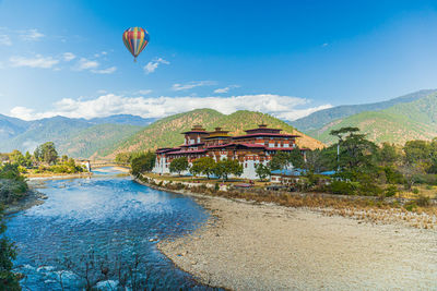 Scenic view of lake by building against sky