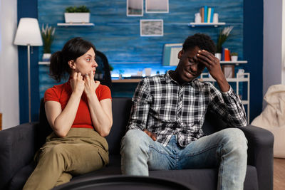 Young couple sitting on sofa