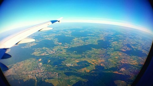 Cropped image of airplane wing over landscape