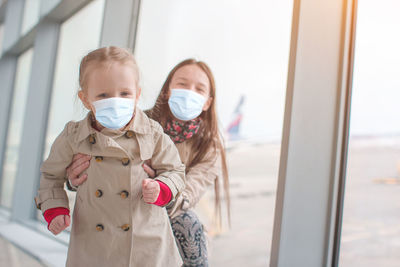 Portrait of boy standing by window