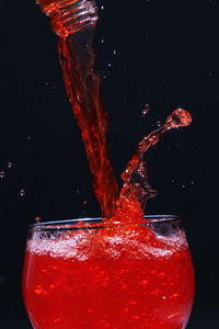 Close-up of water splashing against black background