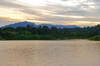 Scenic view of river against sky during sunset