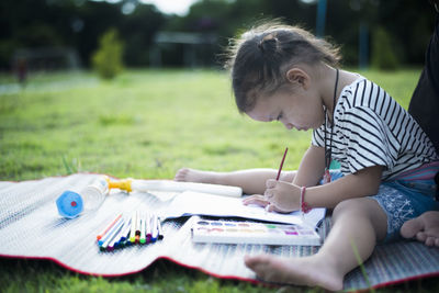 Side view of girl studying at home