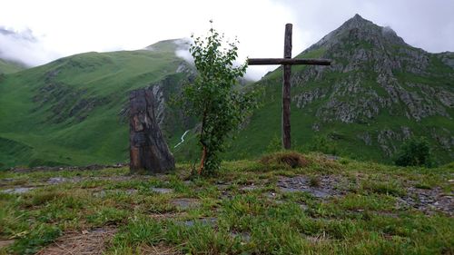 Scenic view of field and mountains against sky