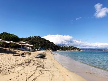 Scenic view of beach against blue sky