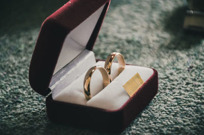 High angle view of wedding rings on bed at home