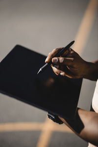 Man with digitalized pen using tablet during sunny day